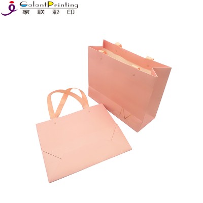 China manufactures high quality custom logo matte coated pink paper shopping bags packaging